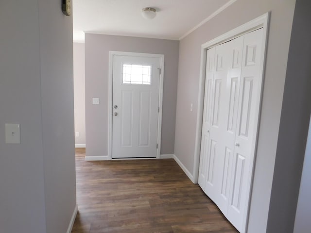 entrance foyer with dark wood-style floors, crown molding, and baseboards