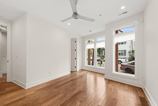 unfurnished room featuring recessed lighting, visible vents, baseboards, and wood finished floors