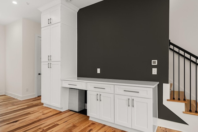 interior space with recessed lighting, baseboards, stairway, light wood-type flooring, and built in study area