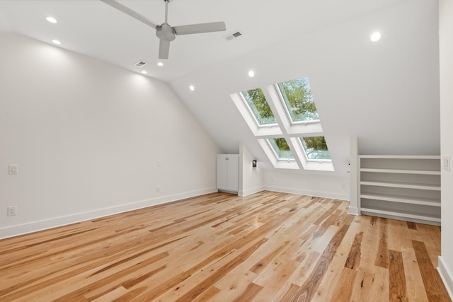 bonus room with recessed lighting, visible vents, light wood-style flooring, lofted ceiling with skylight, and baseboards