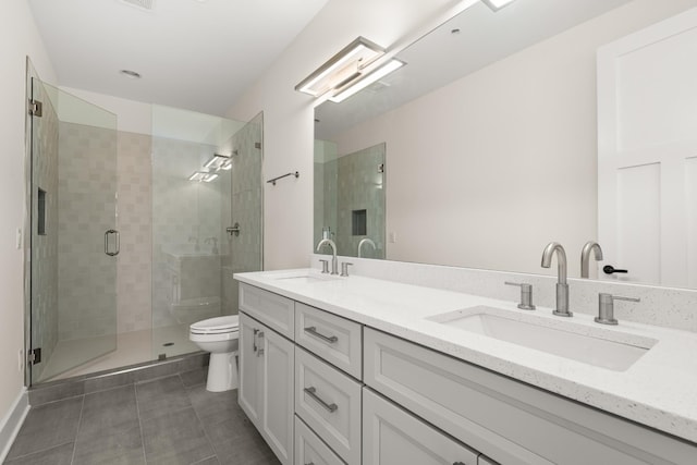 bathroom with toilet, tile patterned flooring, double vanity, and a sink