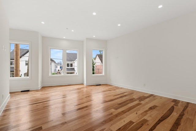 interior space featuring baseboards, light wood finished floors, and recessed lighting