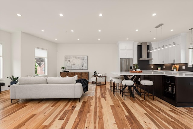 living room featuring light wood finished floors and recessed lighting