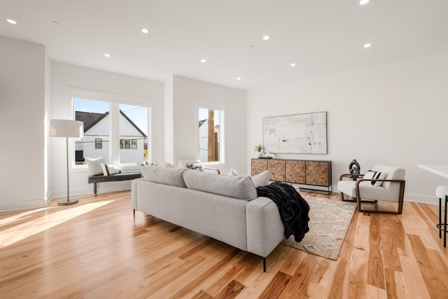 living area featuring light wood finished floors and recessed lighting