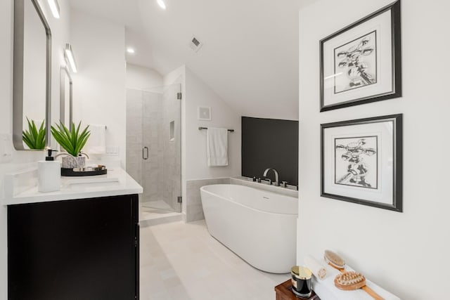 bathroom featuring visible vents, lofted ceiling, a soaking tub, a shower stall, and a sink