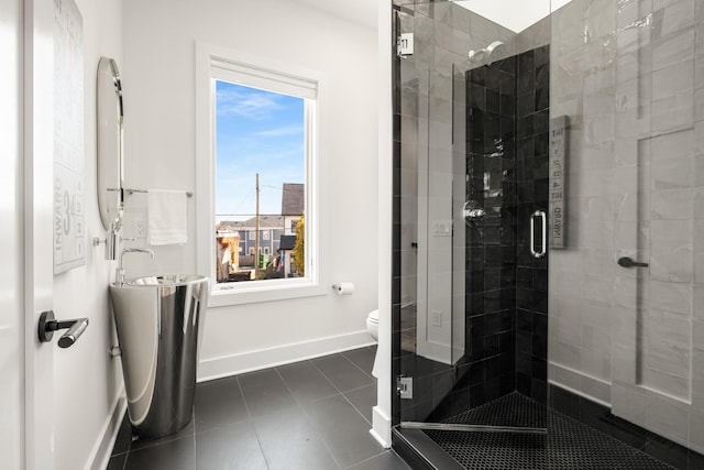 bathroom featuring toilet, vanity, baseboards, a shower stall, and tile patterned floors