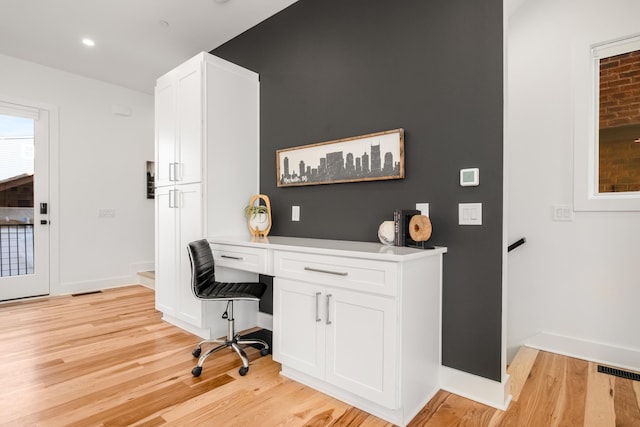 home office featuring built in desk, recessed lighting, visible vents, light wood-type flooring, and baseboards