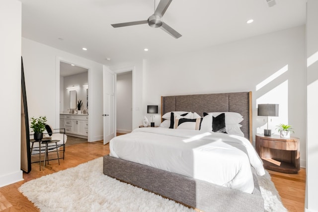 bedroom with baseboards, light wood finished floors, connected bathroom, and recessed lighting