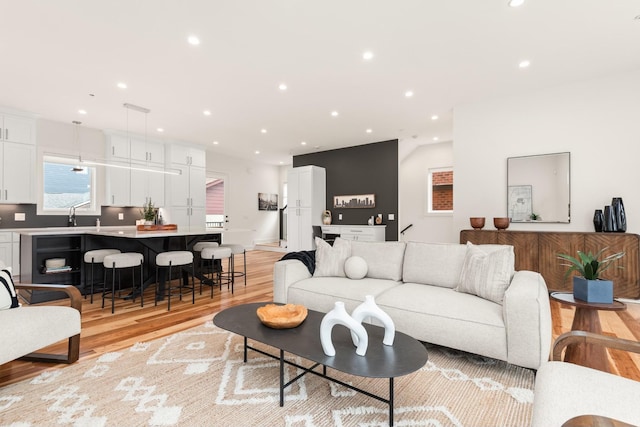 living room featuring light wood finished floors and recessed lighting