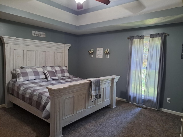 bedroom featuring baseboards, dark colored carpet, and a ceiling fan