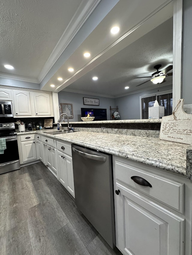 579 Old Celina Rd, Allons, TN 38541 - kitchen with a textured ceiling, stainless steel appliances, dark wood-type flooring, a sink, and crown molding