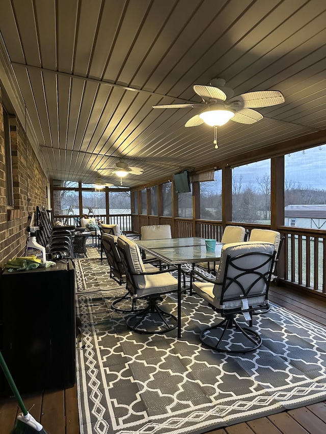 sunroom with a ceiling fan and wooden ceiling