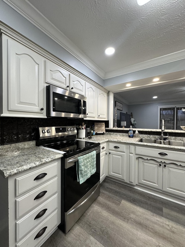 579 Old Celina Rd, Allons, TN 38541 - kitchen featuring dark wood finished floors, tasteful backsplash, appliances with stainless steel finishes, ornamental molding, and a sink