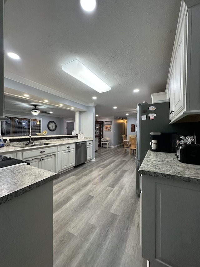 579 Old Celina Rd, Allons, TN 38541 - kitchen with light wood finished floors, white cabinets, ceiling fan, stainless steel appliances, and a textured ceiling