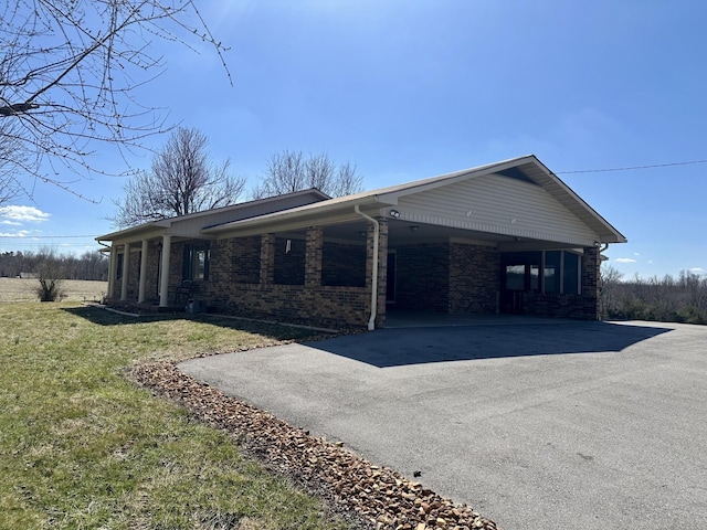 579 Old Celina Rd, Allons, TN 38541 - view of property exterior featuring driveway, brick siding, and a lawn