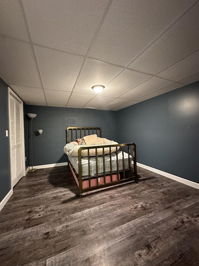579 Old Celina Rd, Allons, TN 38541 - bedroom featuring a paneled ceiling, wood finished floors, concrete block wall, and baseboards