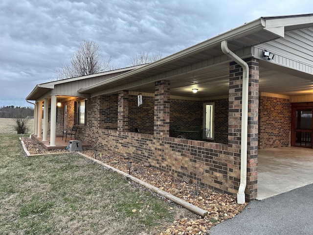 579 Old Celina Rd, Allons, TN 38541 - view of side of home with a carport, brick siding, and driveway
