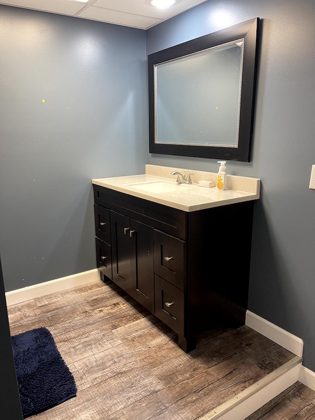 579 Old Celina Rd, Allons, TN 38541 - bathroom featuring a drop ceiling, vanity, baseboards, and wood finished floors