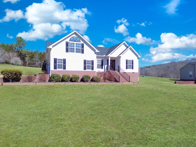 view of front of home with brick siding and a front yard