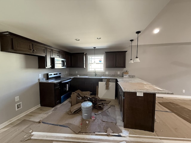 kitchen with range with electric stovetop, stainless steel microwave, dark brown cabinetry, a sink, and a peninsula