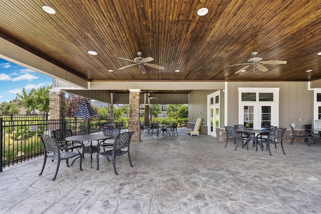 view of patio / terrace featuring outdoor dining space, fence, french doors, and ceiling fan