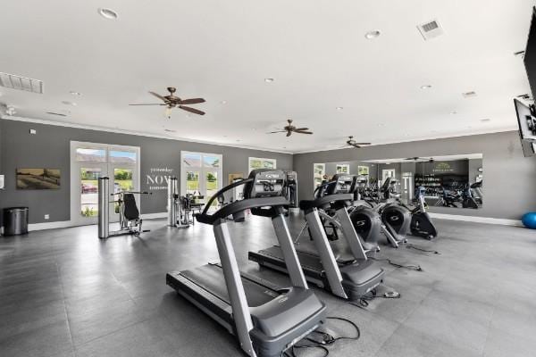 gym featuring visible vents, baseboards, and crown molding