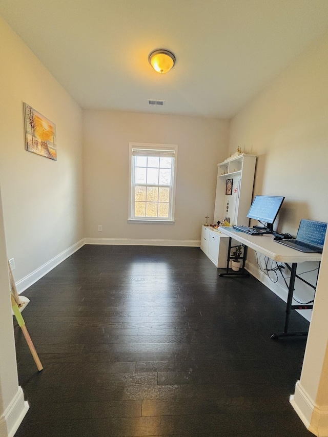 office with visible vents, baseboards, and wood finished floors