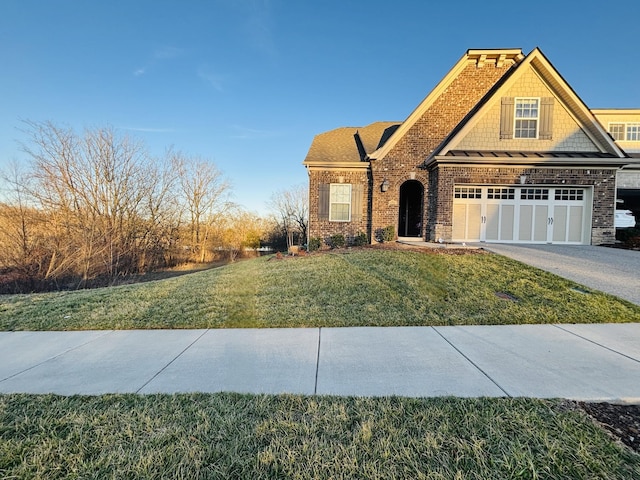 view of front of house with a front lawn, an attached garage, and driveway