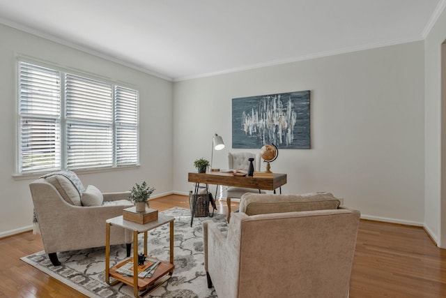 living room with light wood finished floors, baseboards, and crown molding