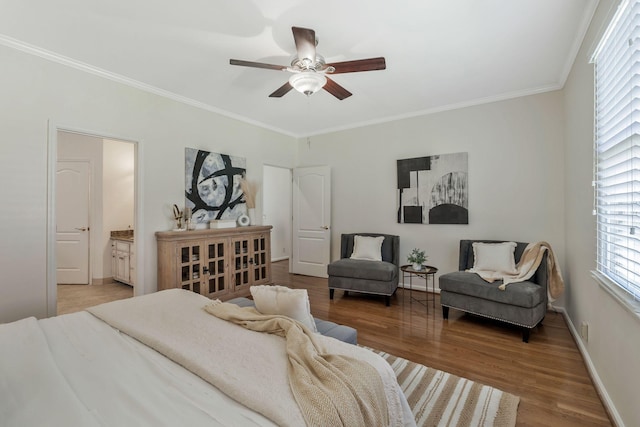 bedroom featuring ensuite bathroom, ornamental molding, a ceiling fan, wood finished floors, and baseboards