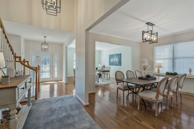 dining room with an inviting chandelier, wood finished floors, and a healthy amount of sunlight