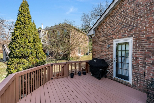 wooden terrace featuring a grill