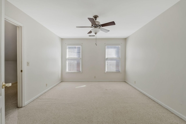 unfurnished room featuring carpet, a ceiling fan, and baseboards