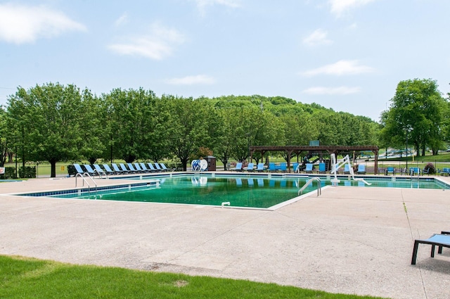 community pool with a patio area and a pergola