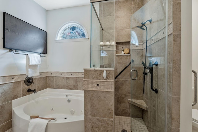 full bath featuring a tub with jets and a stall shower