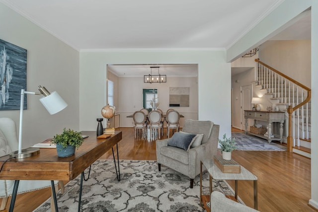 interior space with a chandelier, crown molding, stairway, and wood finished floors