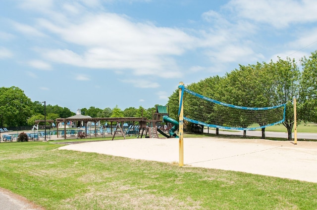 view of property's community featuring a yard, playground community, and volleyball court