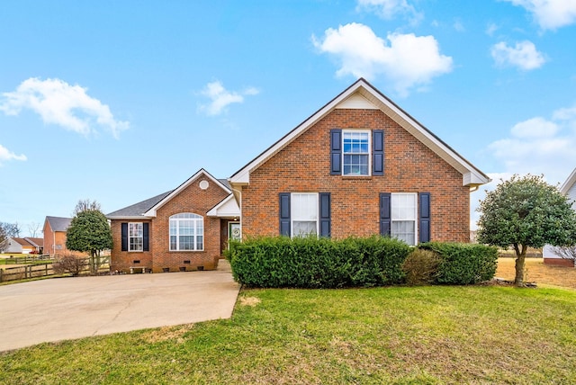 traditional-style house featuring brick siding, crawl space, and a front lawn