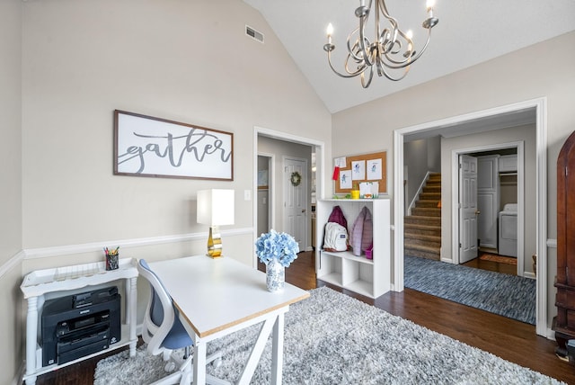 office space with washer / clothes dryer, visible vents, an inviting chandelier, wood finished floors, and high vaulted ceiling