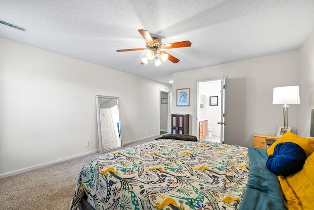 bedroom featuring a textured ceiling, carpet, visible vents, and baseboards