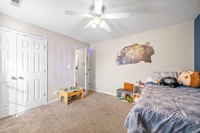 bedroom with visible vents, carpet flooring, a textured ceiling, and baseboards