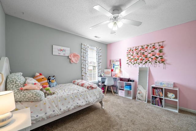 carpeted bedroom featuring a ceiling fan, visible vents, and a textured ceiling