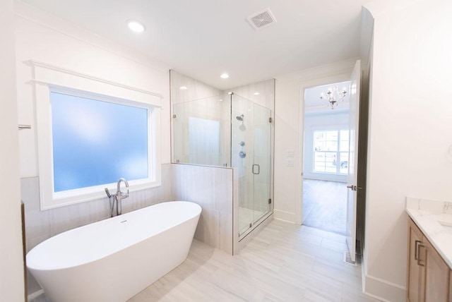 full bath featuring recessed lighting, visible vents, a freestanding bath, a shower stall, and vanity