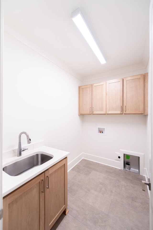 clothes washing area featuring washer hookup, cabinet space, hookup for an electric dryer, a sink, and baseboards