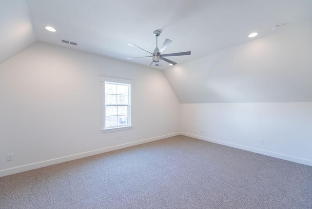 additional living space with lofted ceiling, visible vents, ceiling fan, and baseboards