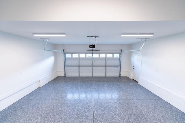 garage featuring baseboards and a garage door opener