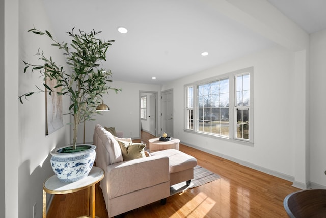 living room with baseboards, wood finished floors, and recessed lighting