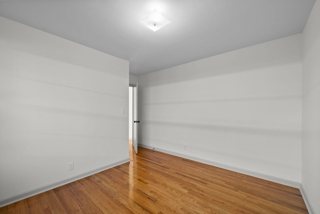 empty room with wood finished floors and baseboards