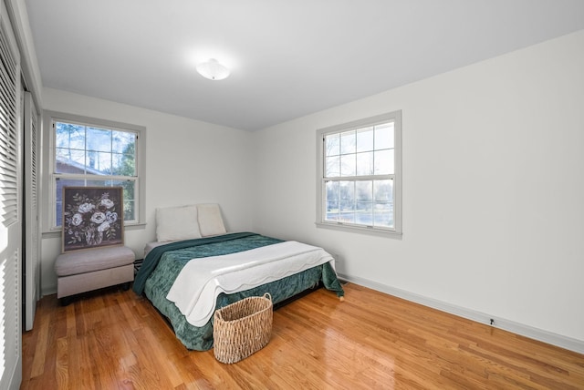 bedroom featuring baseboards and wood finished floors