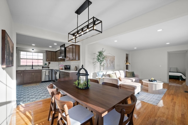 dining space featuring recessed lighting and light wood finished floors